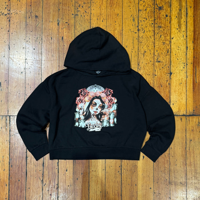Black hoodie with a graphic design on a wooden surface
